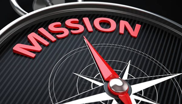 3d render image.  Compass needle pointing the green word mission.